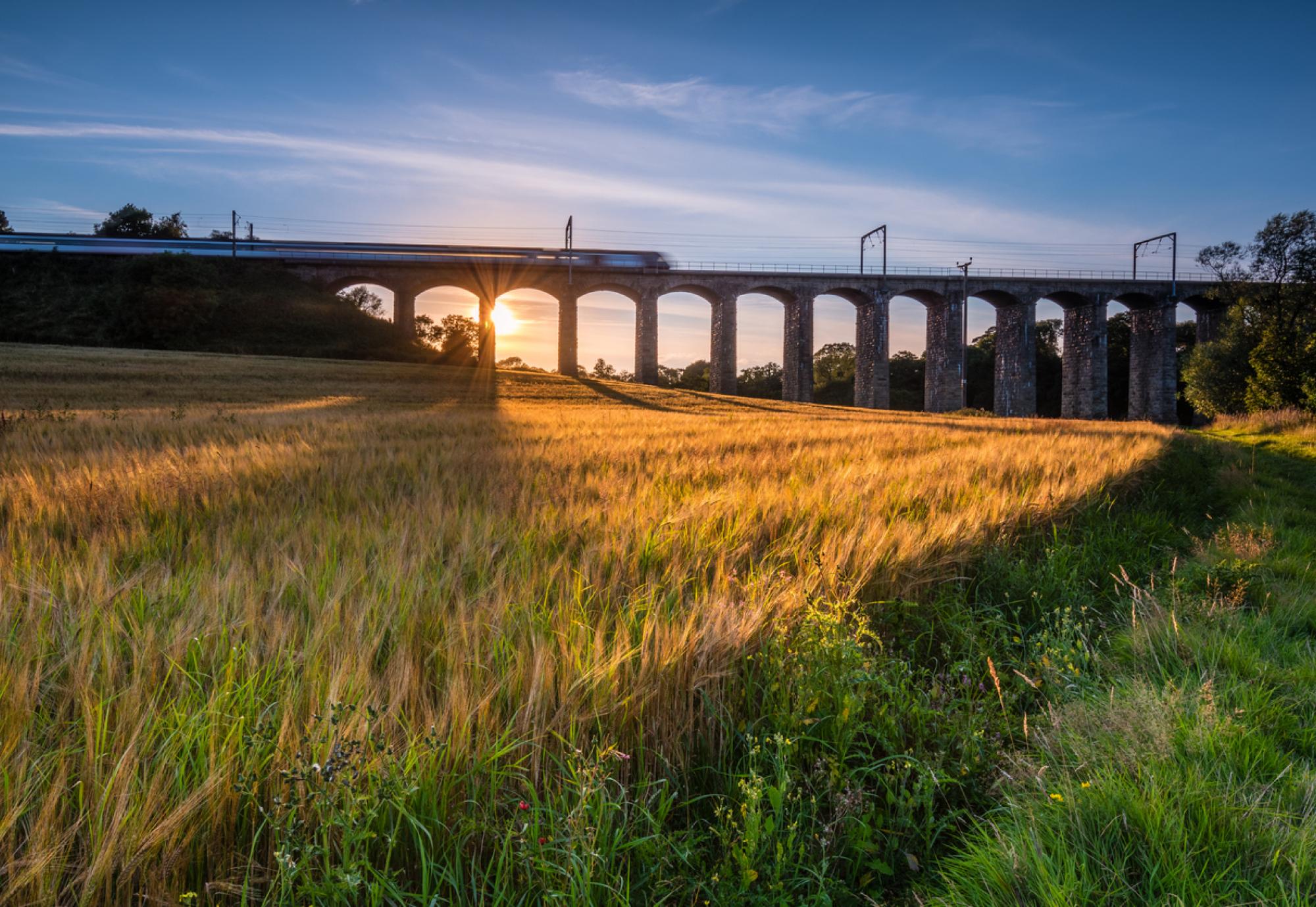 Train crosses a bridge at Lesbury, Northumberland