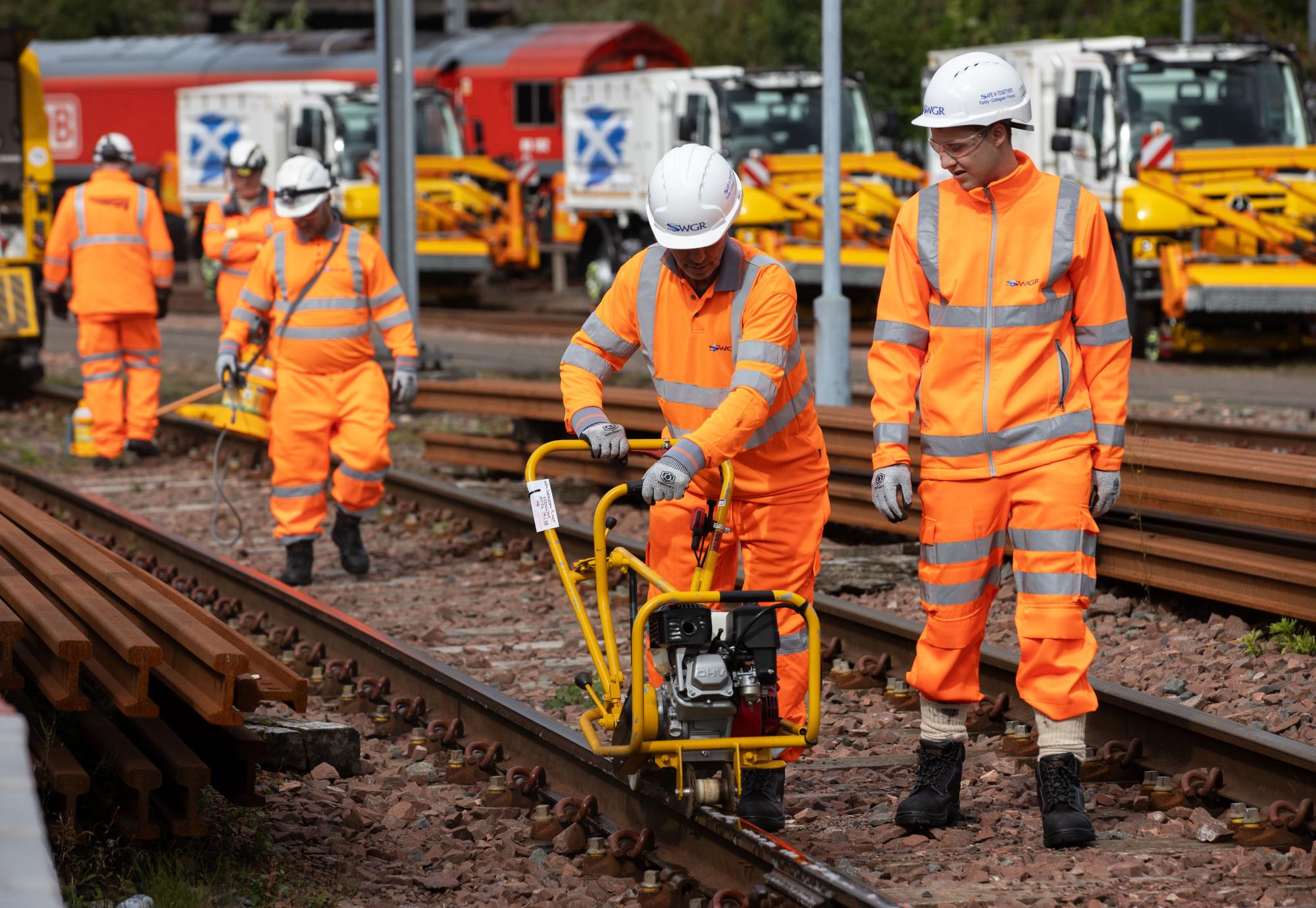 Leaf busting team cleaning the rails