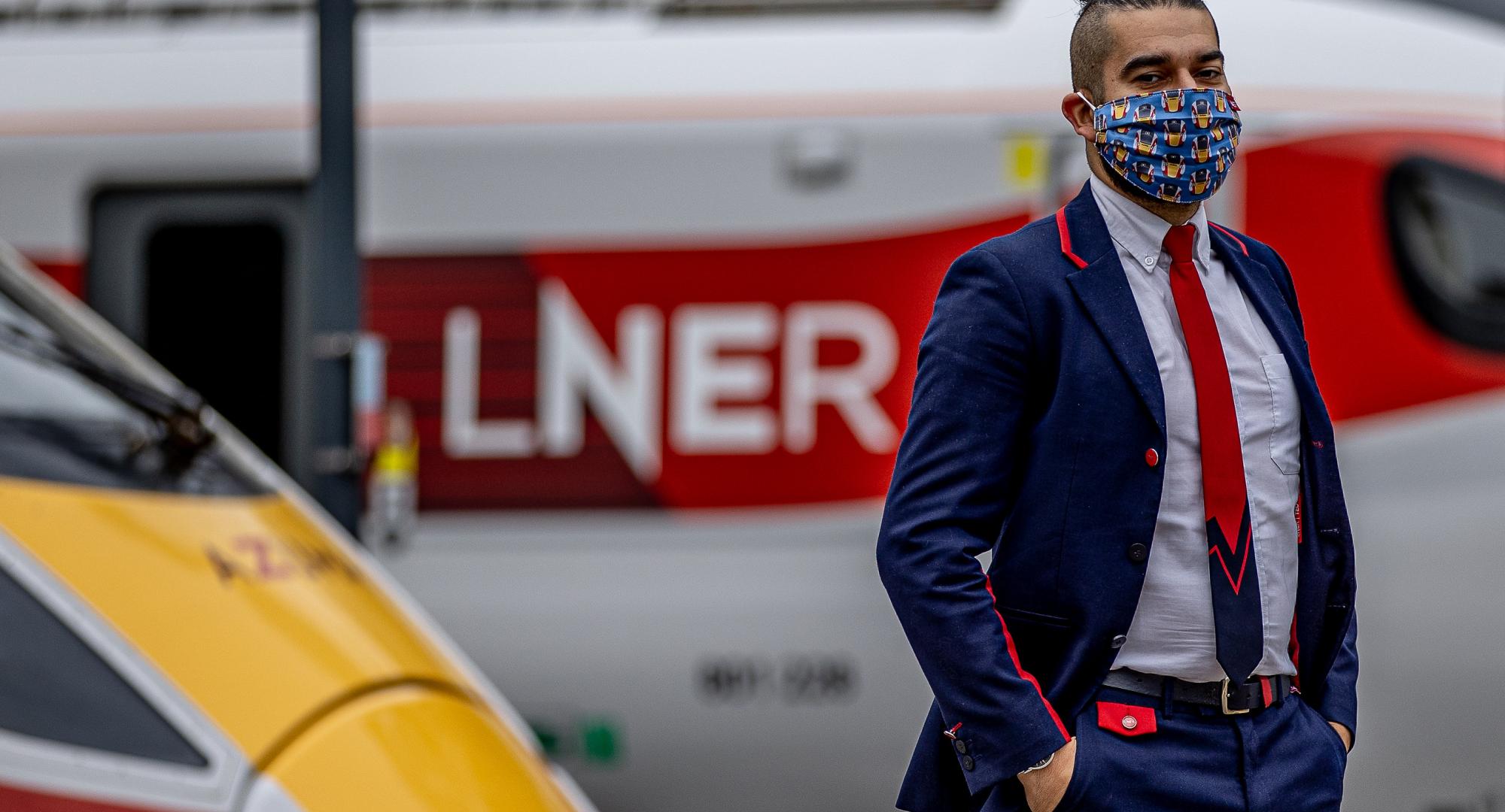 LNER Station Support Assistant Emrah Mehmet wearing the LNER Azuma Mask at London King’s Cross Station.