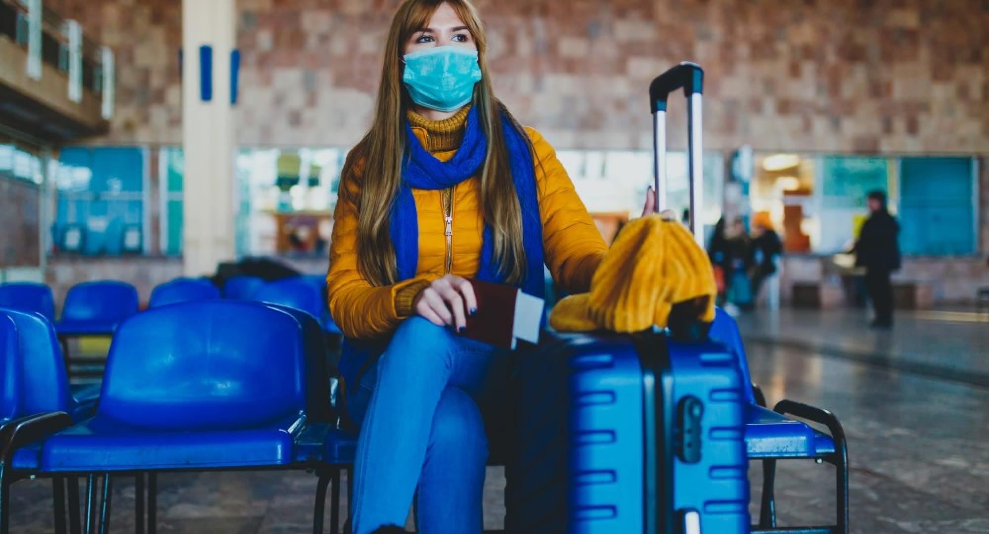 Woman at station waiting for missed or cancelled transport due to a coronavirus