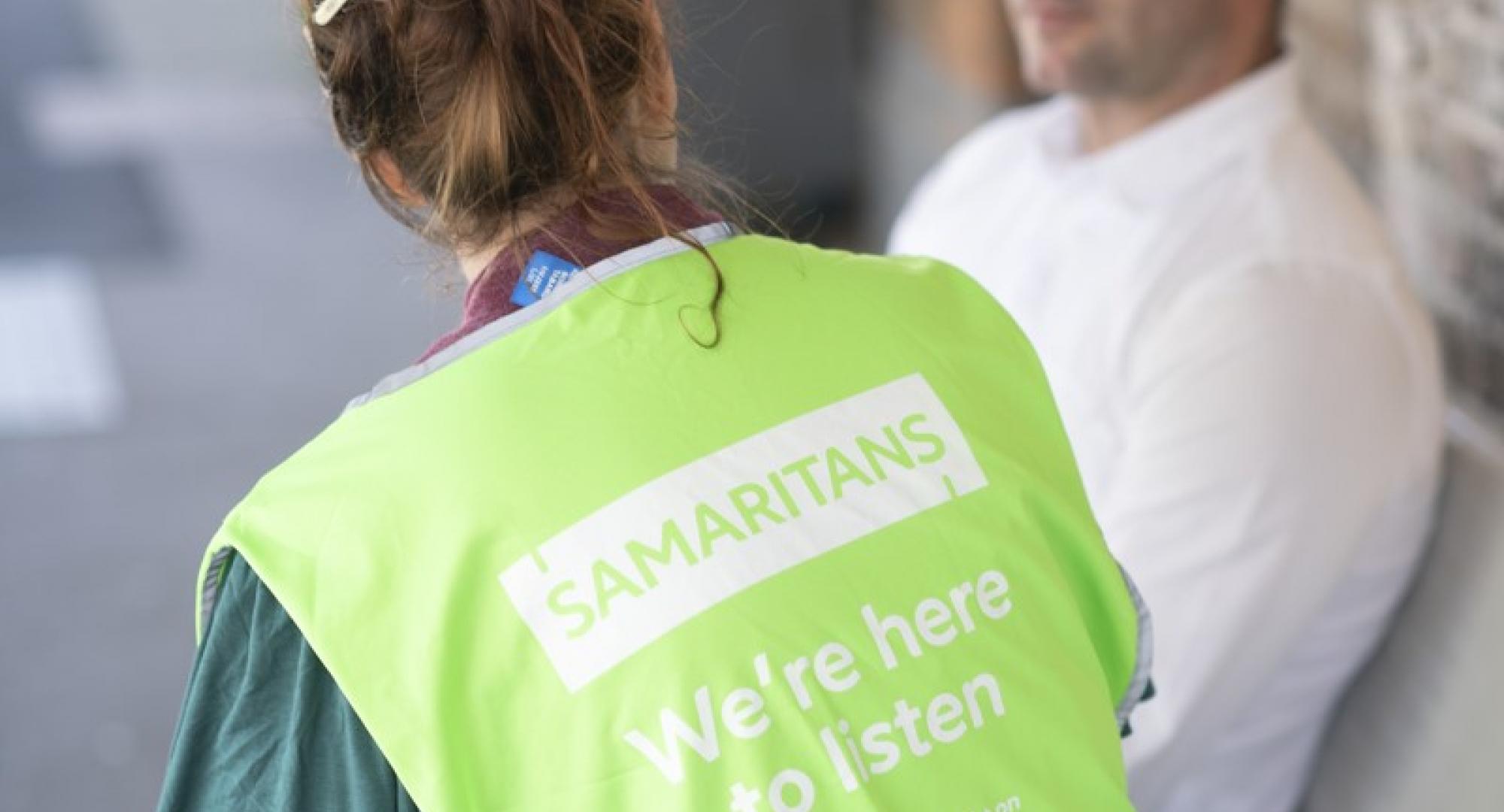 Samaritans volunteer speaking with a male 