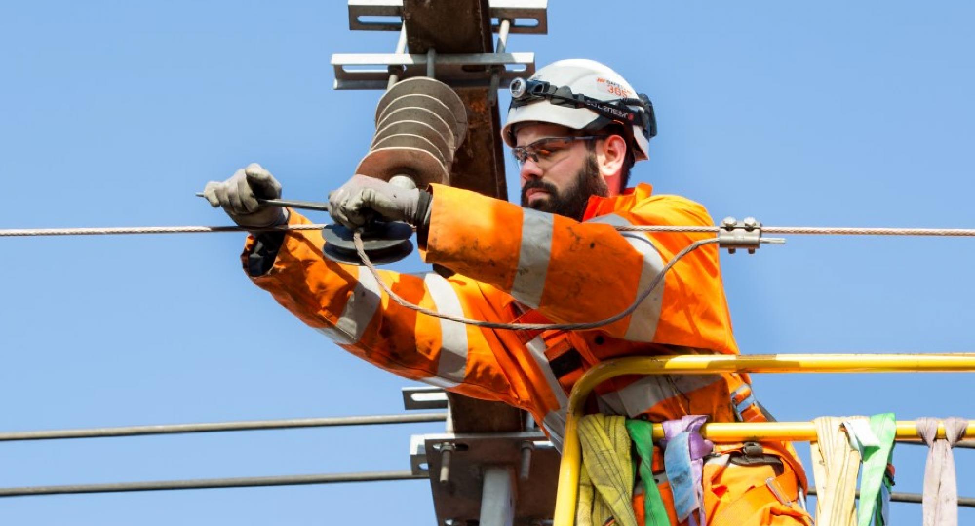 Man doing overhead line equipment work 