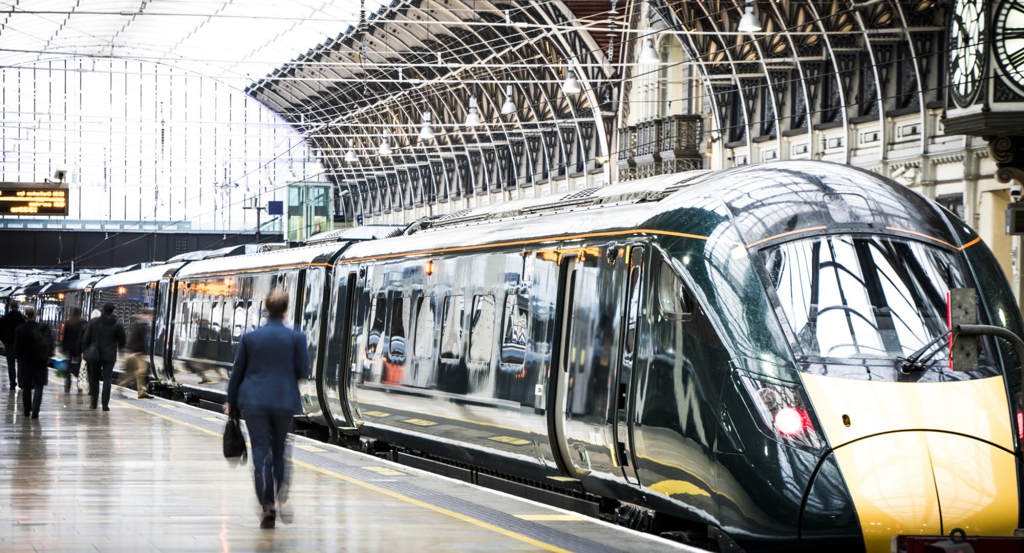 Commuters wander around a train platform