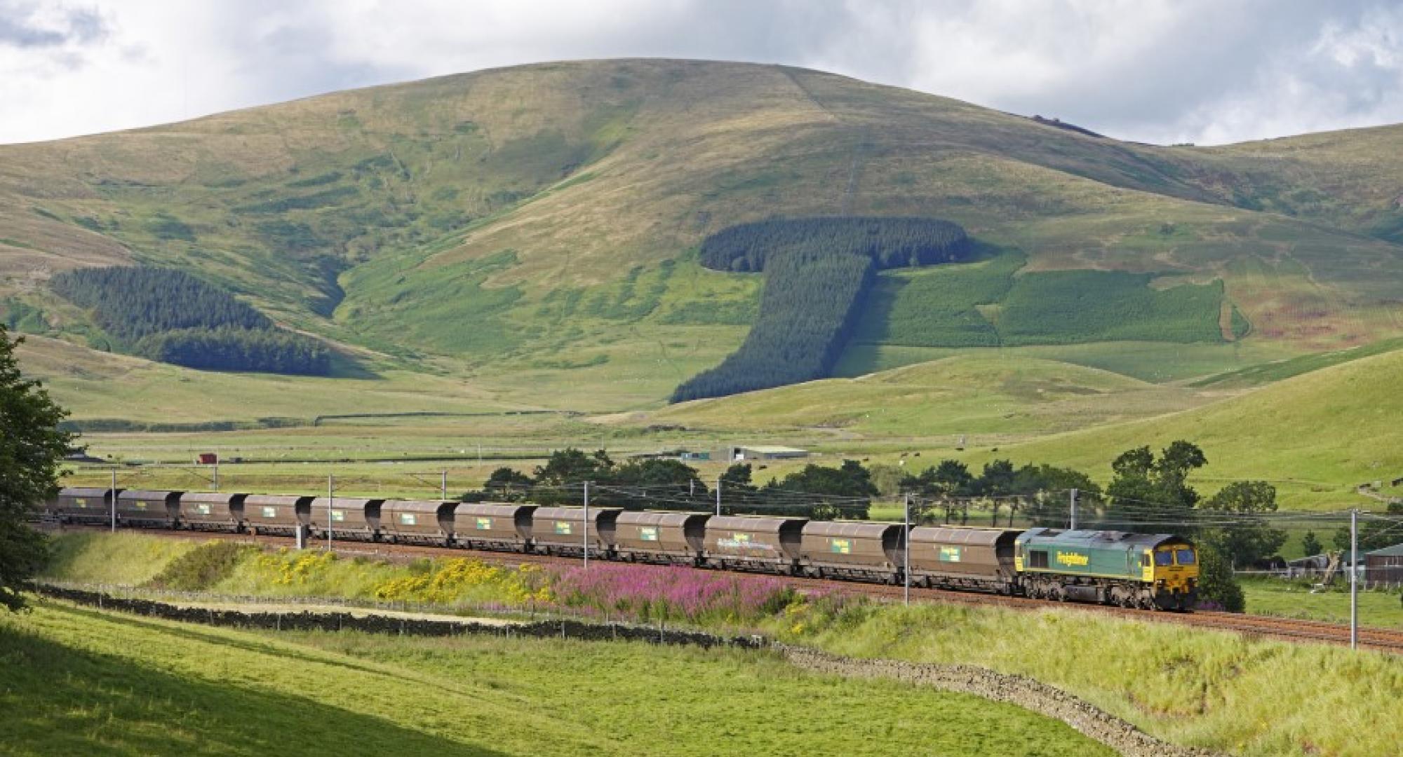 reightliner Heavy Haul coal train as it passes through scenic Scottish countryside.