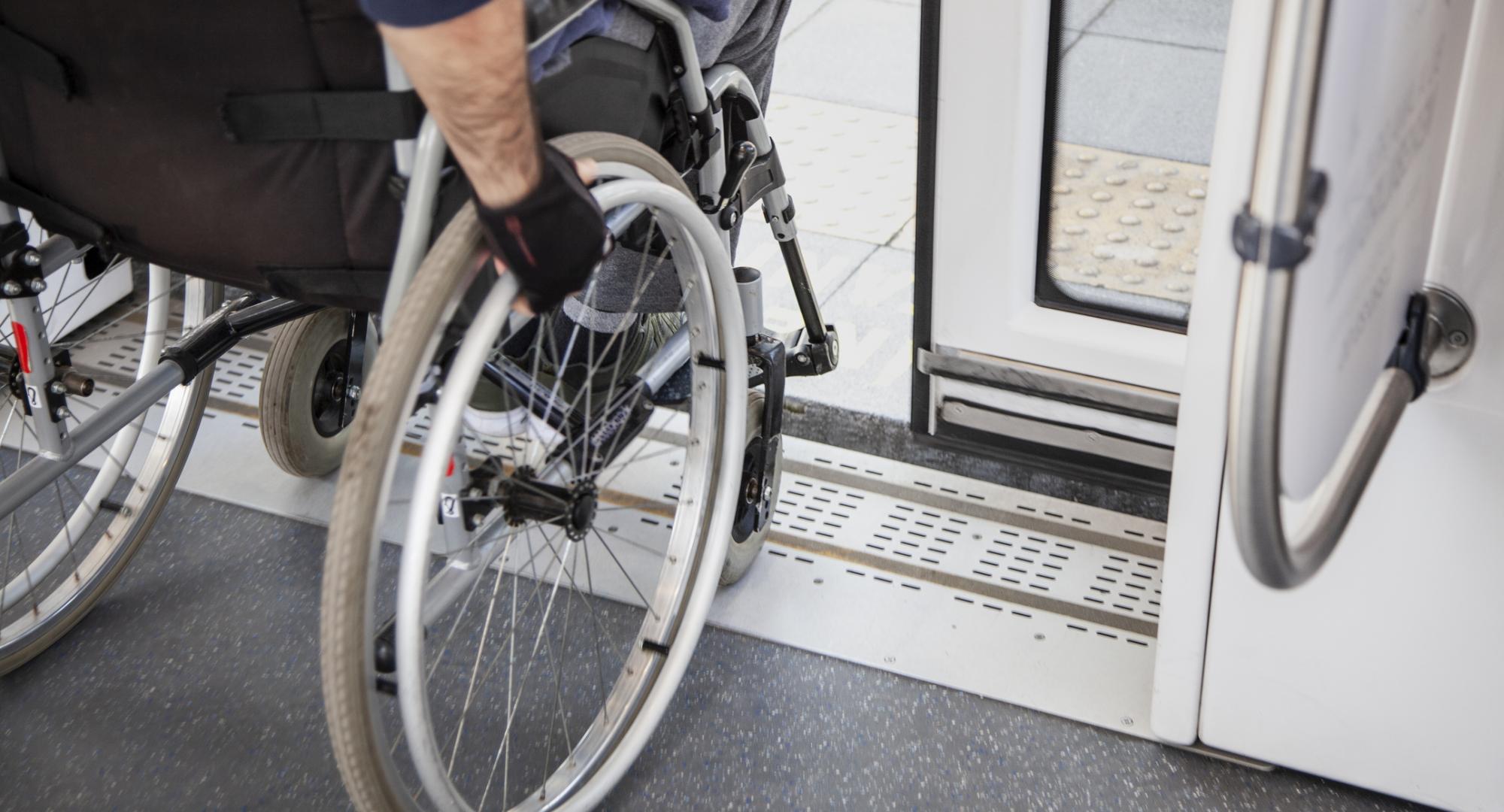 Passenger in a wheelchair disembarking from a train