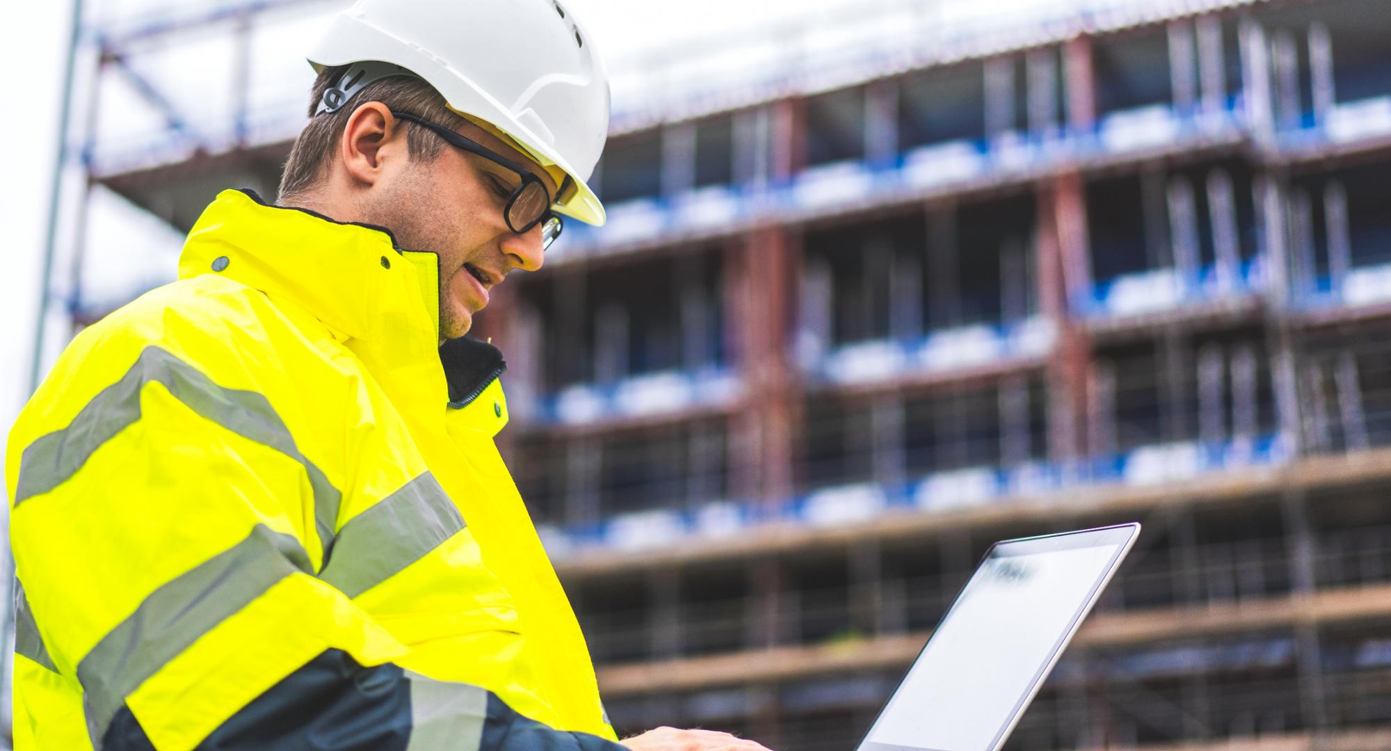 Industrial engineer looking at plans on site