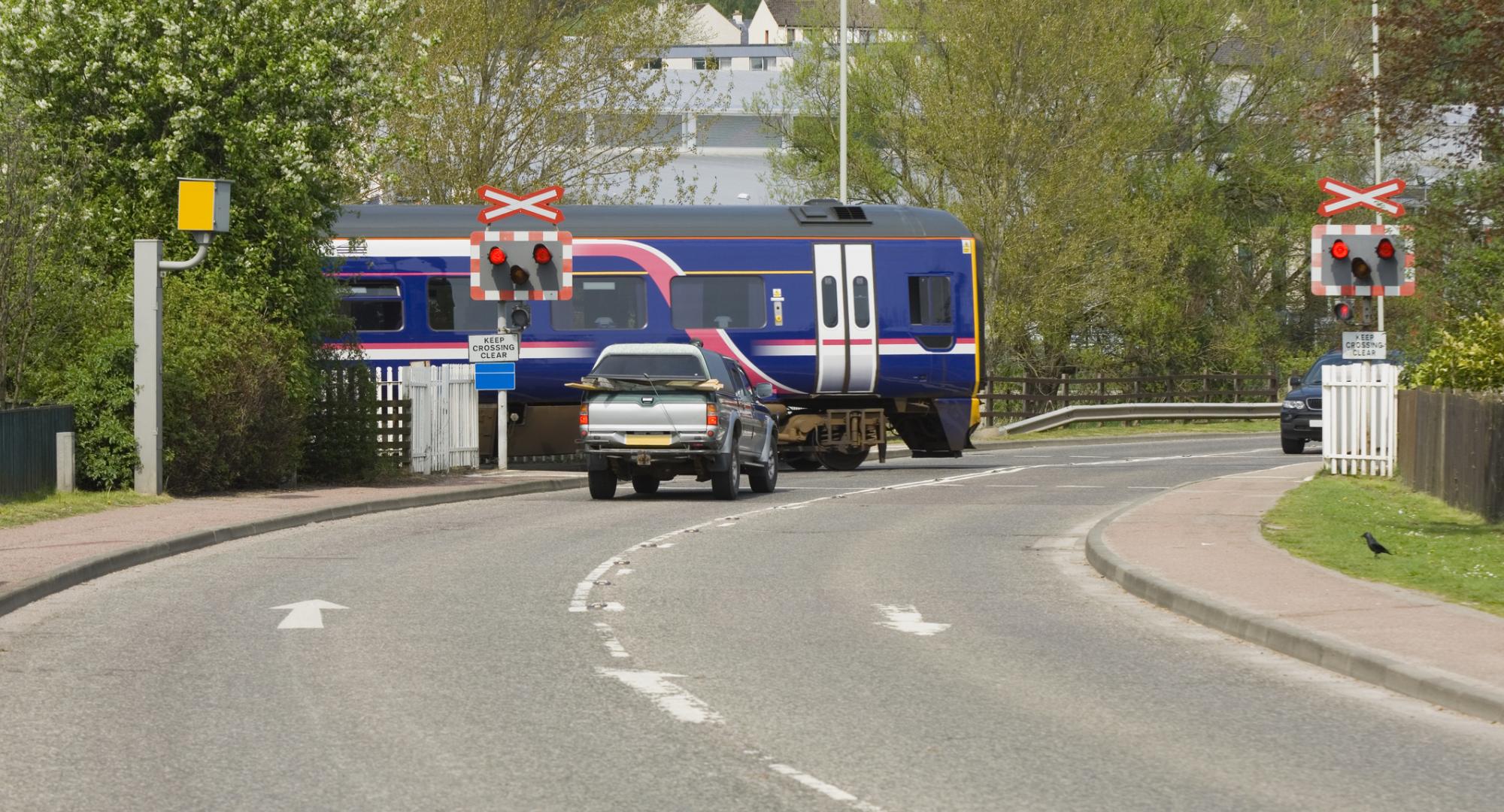 Train crossing a road at a level crossing