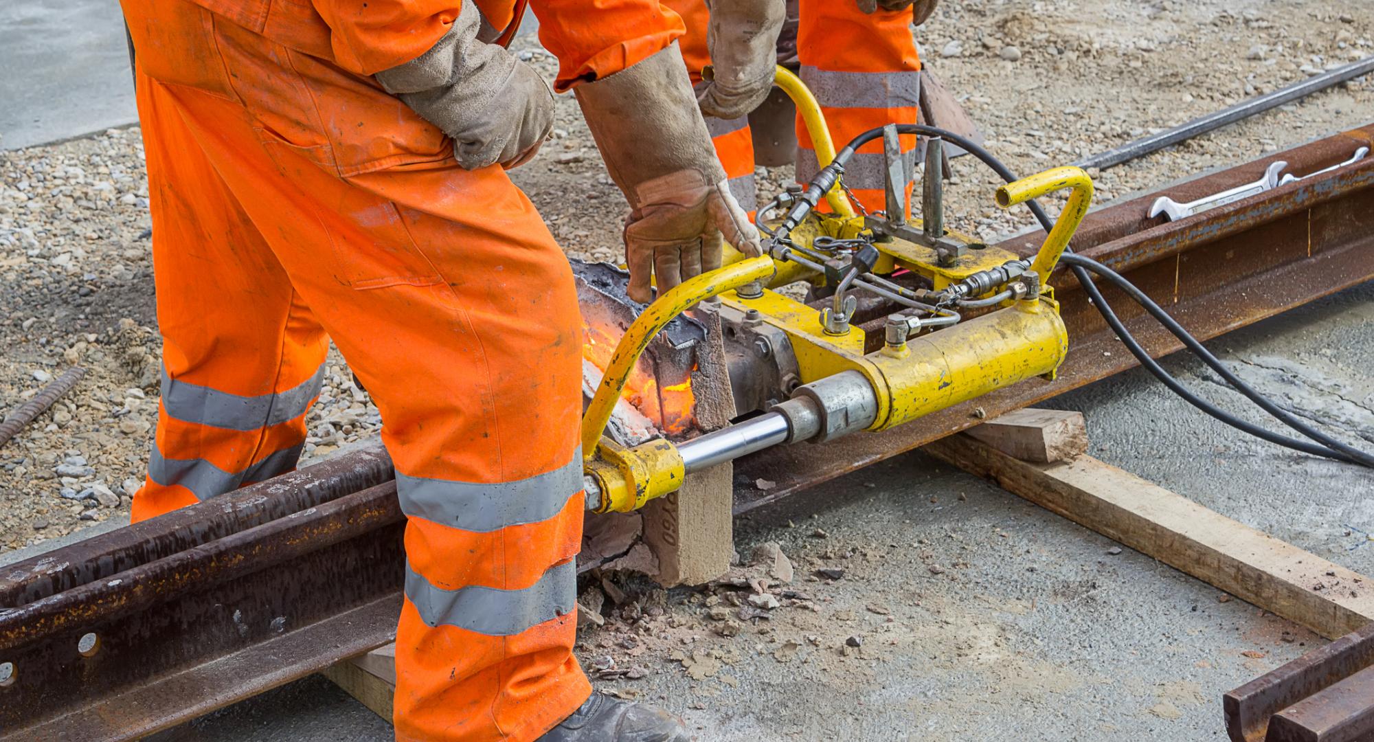 Weld trimmer being used by workers