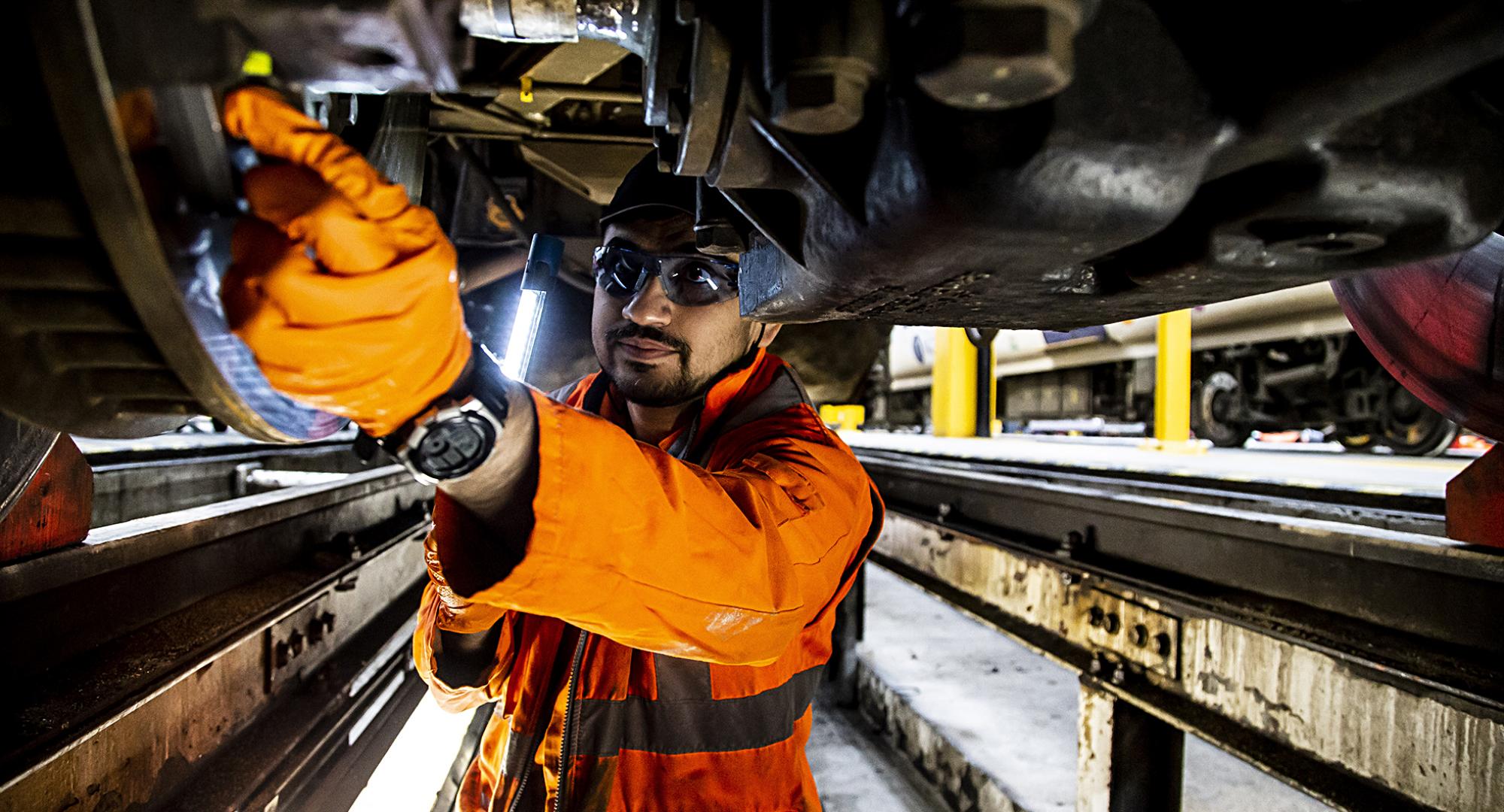 Engineer works on train