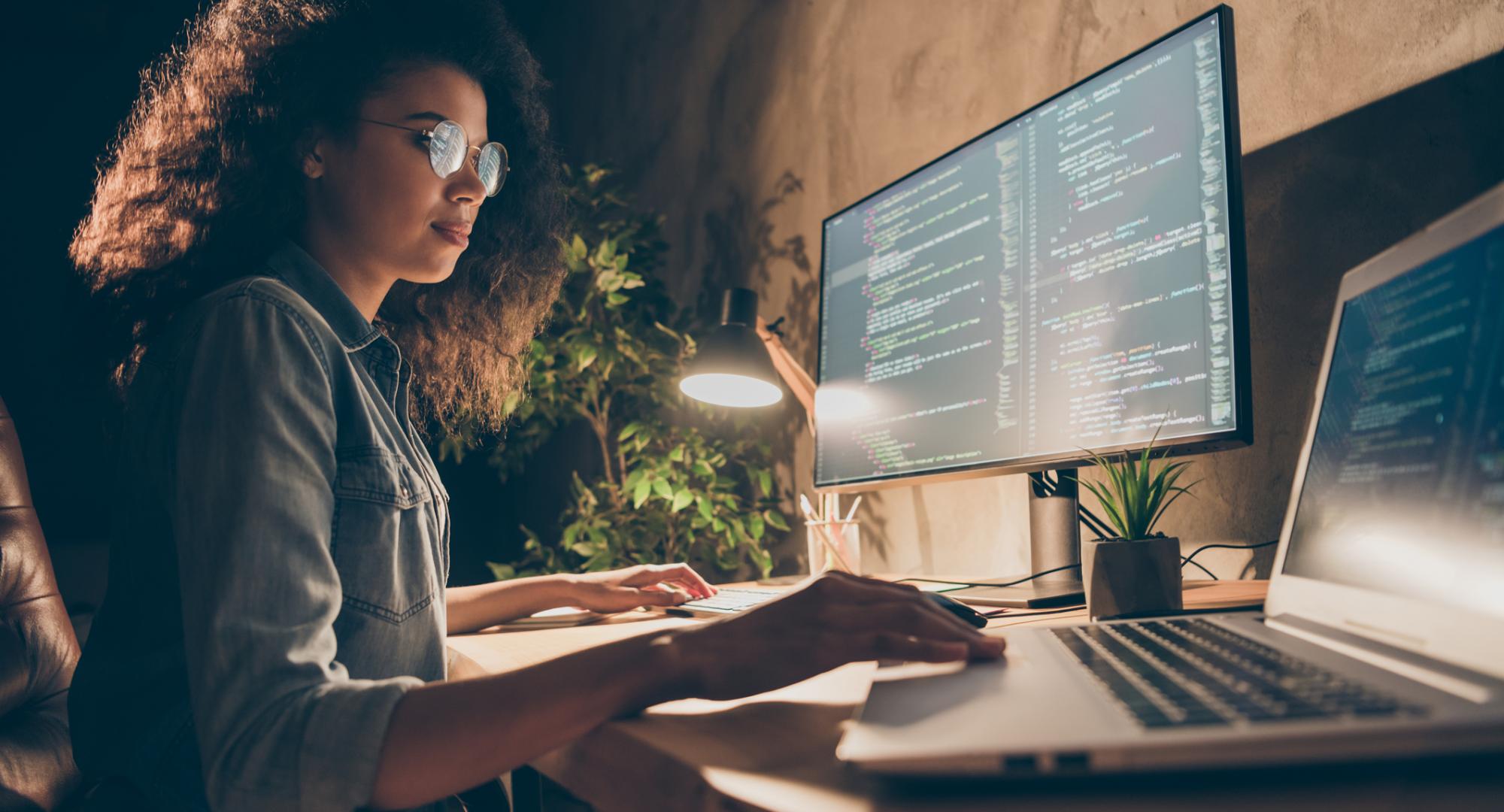 Young woman using a laptop to code