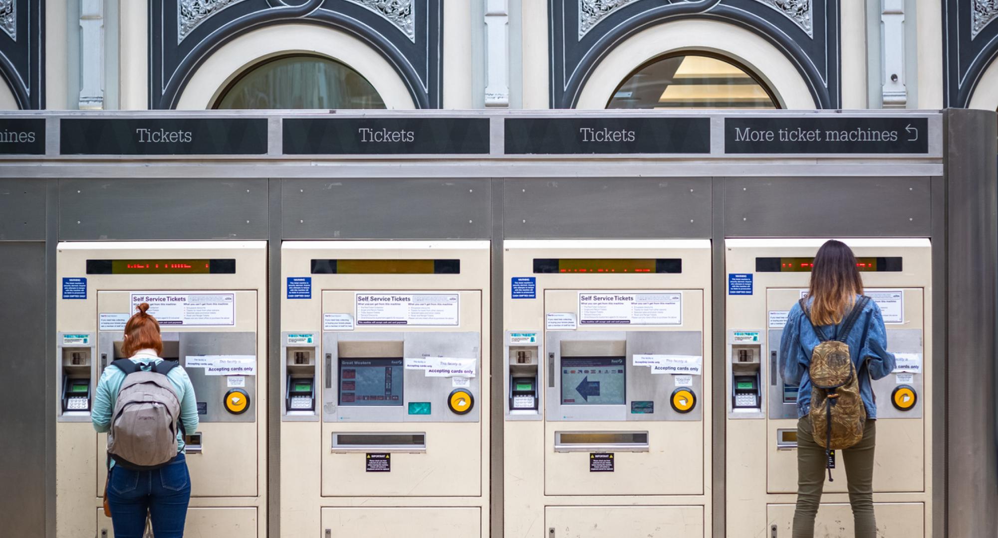 Passengers use ticket machines