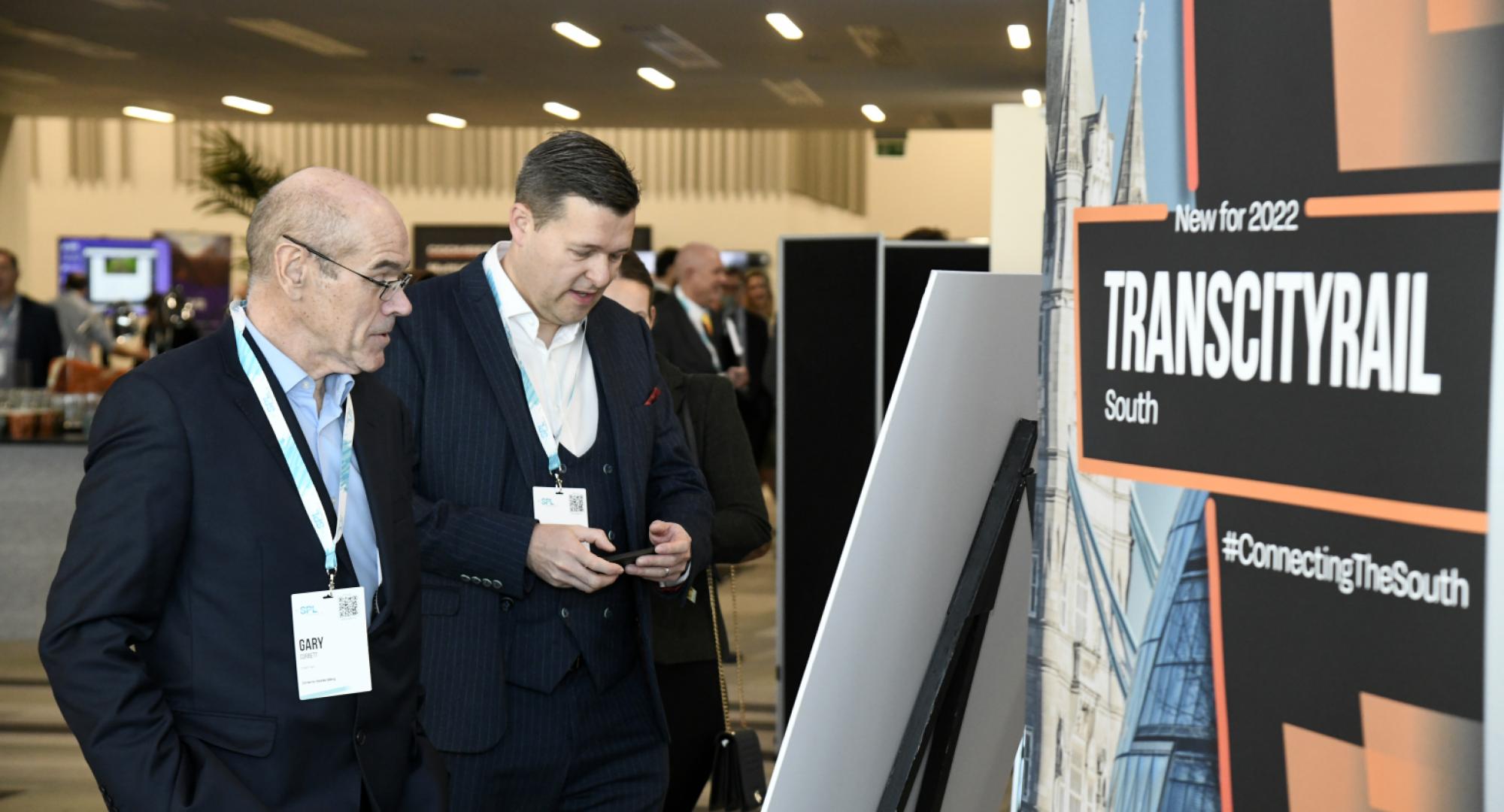 Attendees looking at exhibit at TCR Midlands 2022 event