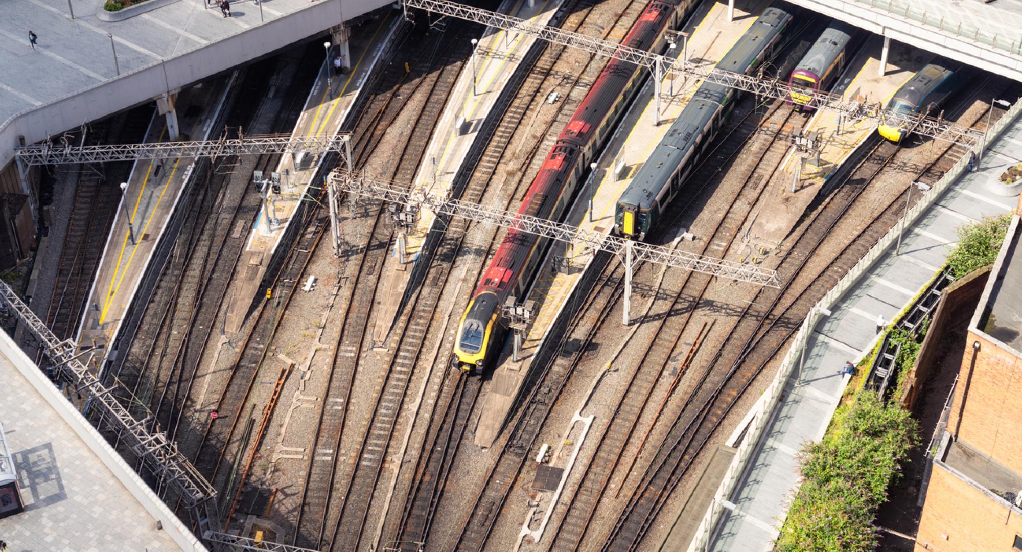 An aerial view of people walking on the pedestrianised paving above trains outside Birmingham's New Street station, in the city centre. Provided via Istock 