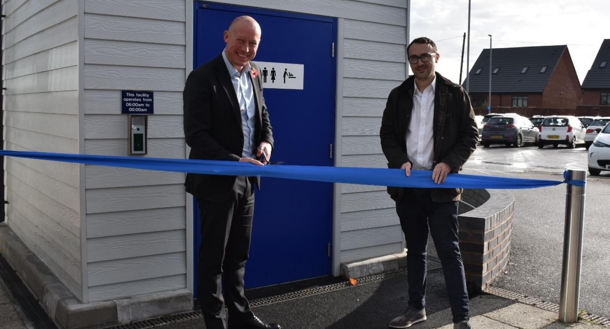 Chris Jackson and Simon Elliott open the new toilet pod by cutting a ribbon, via Northern