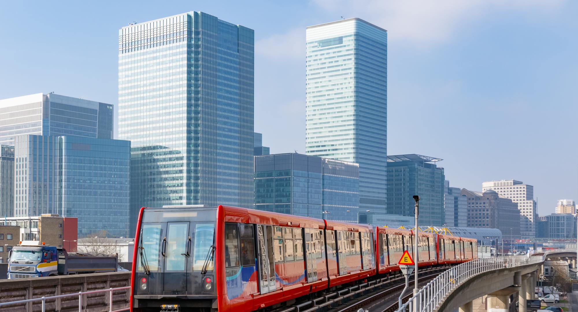 Docklands light railway in London with Canary Wharf in the background, via Istock 