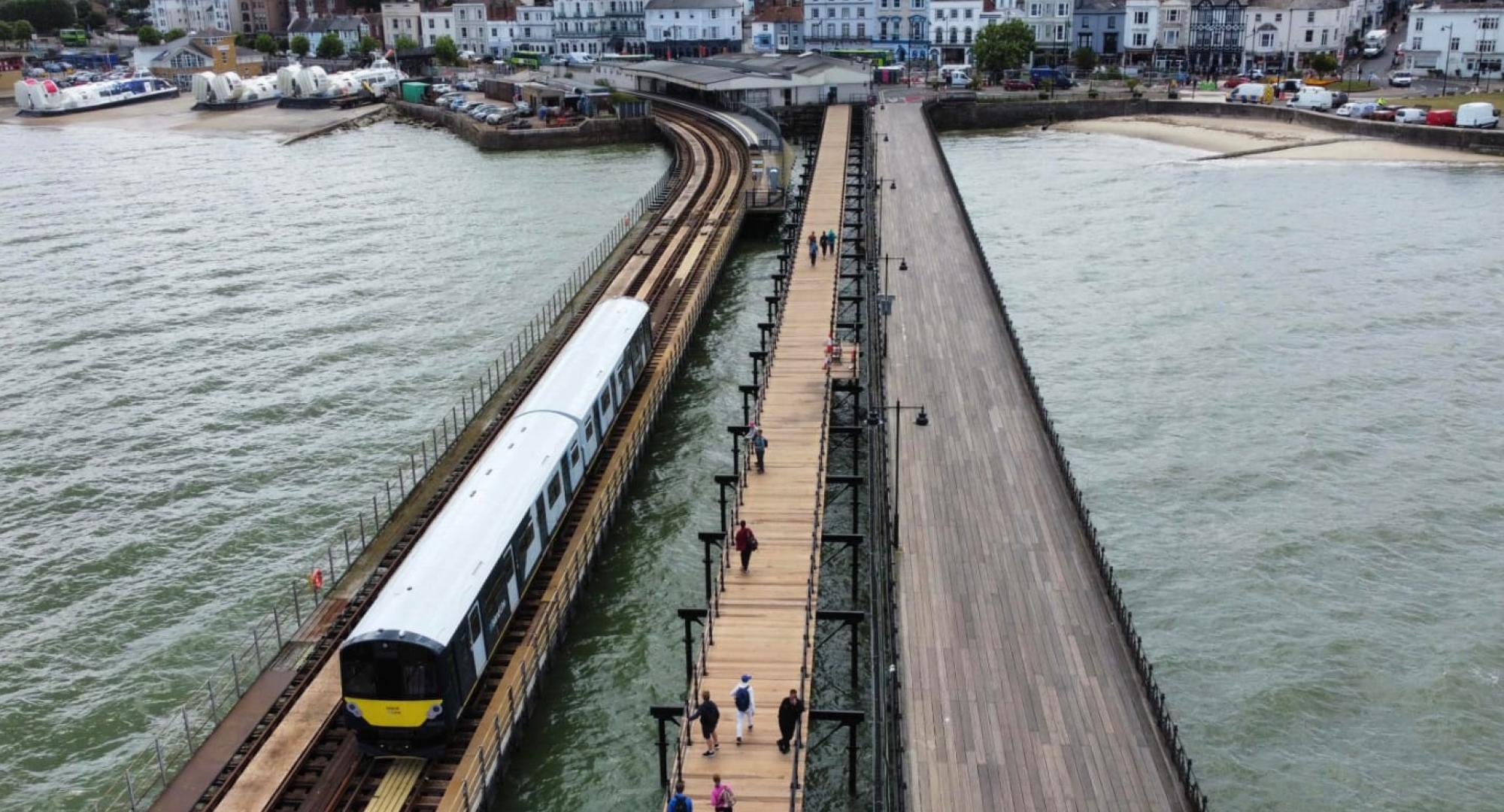 Aerial shot of a South Western Railway train running on the Ryde Pier on the Isle of Wight in July 2023