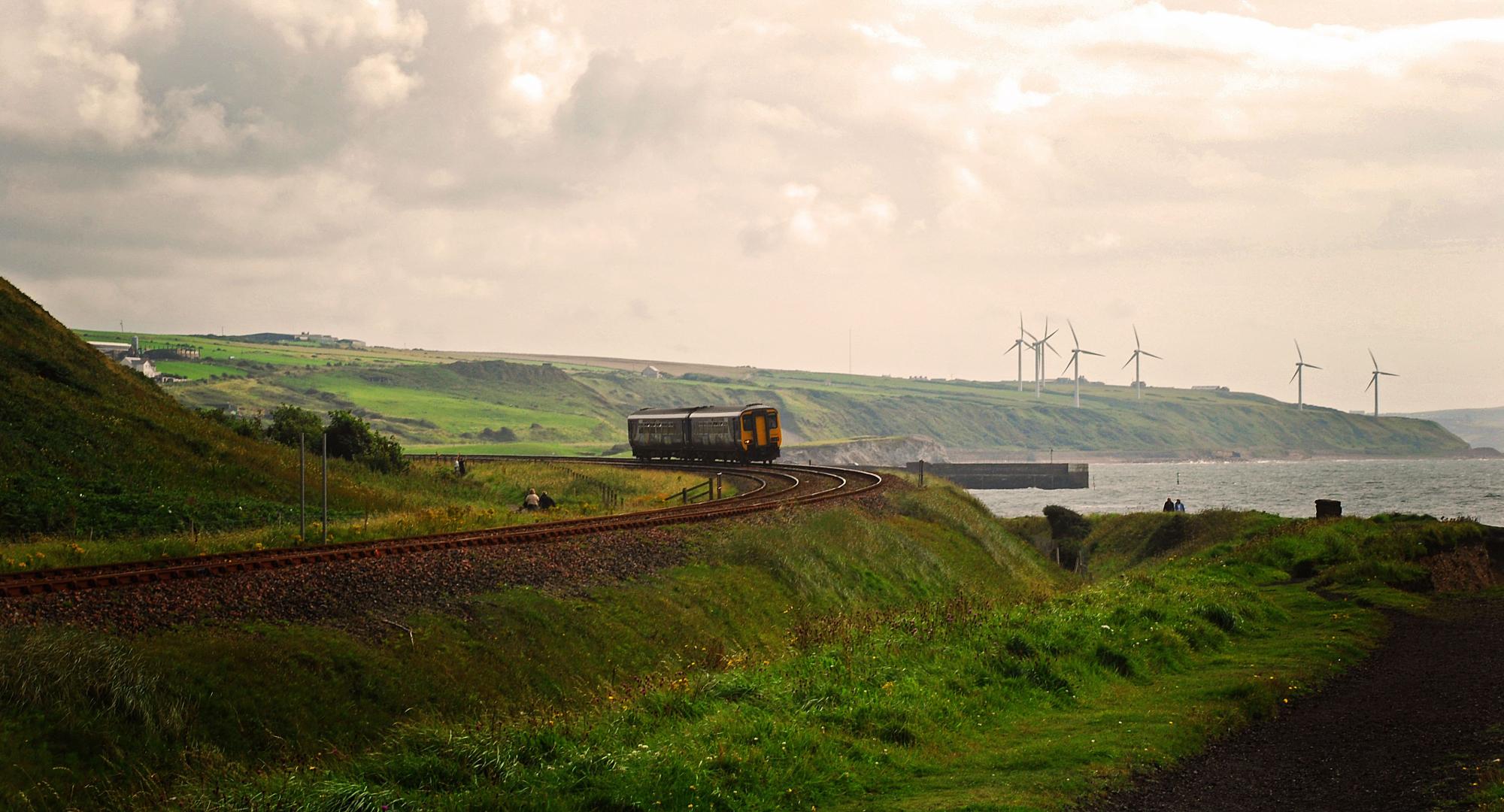 A railway carriage in front of a lake with a cloudy sky in the background, Whitehaven, Cumbria, England