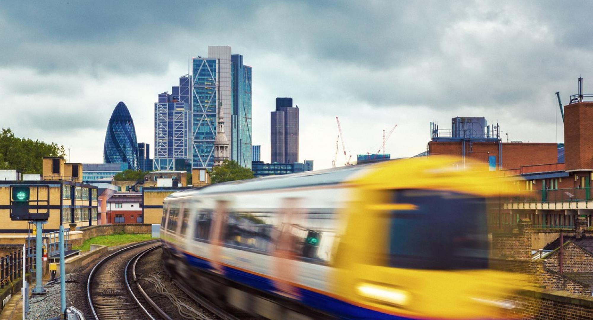 London Overground train in front of London skyline