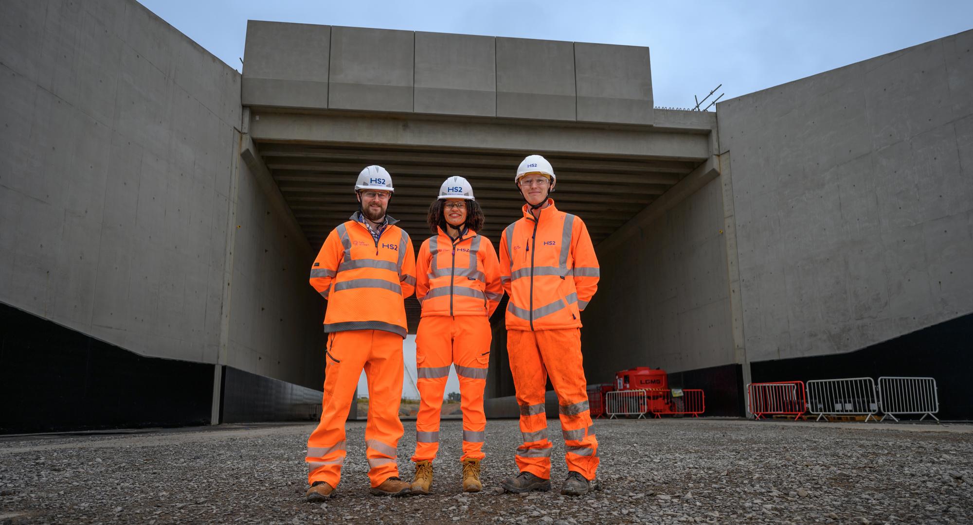 Picture of three HS2 workers stood in front of the new bridge