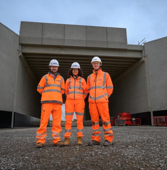 Picture of three HS2 workers stood in front of the new bridge