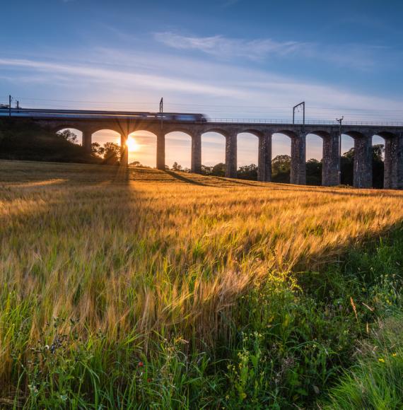 Train crosses a bridge at Lesbury, Northumberland